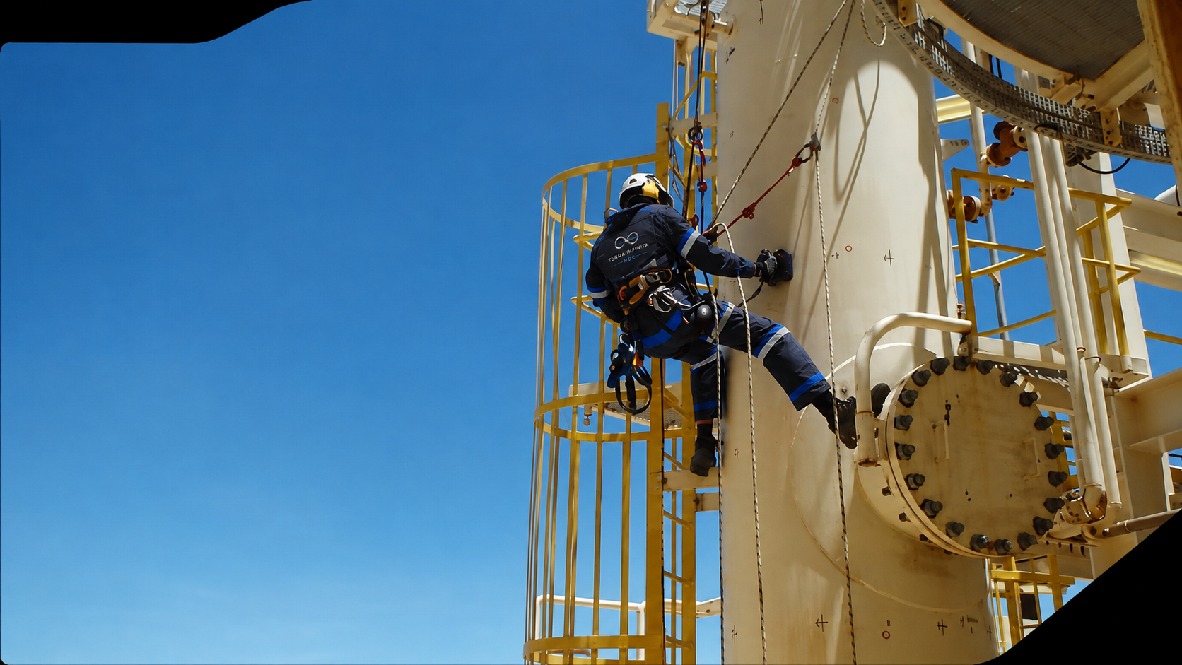 TerraInfinita rope-access technician inspecting an industrial vessel at height